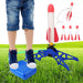 Child stomping on blue pump with air-powered rocket launcher and foam rockets on grassy field.